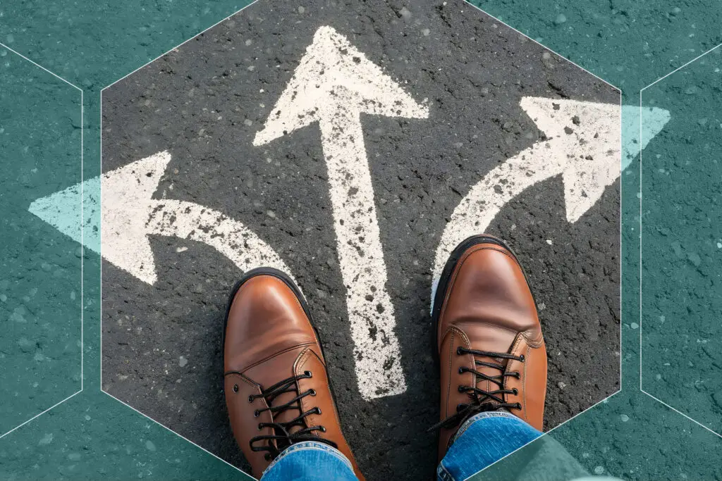 Three white arrows on ground pointing left, straight and right with feet on arrows